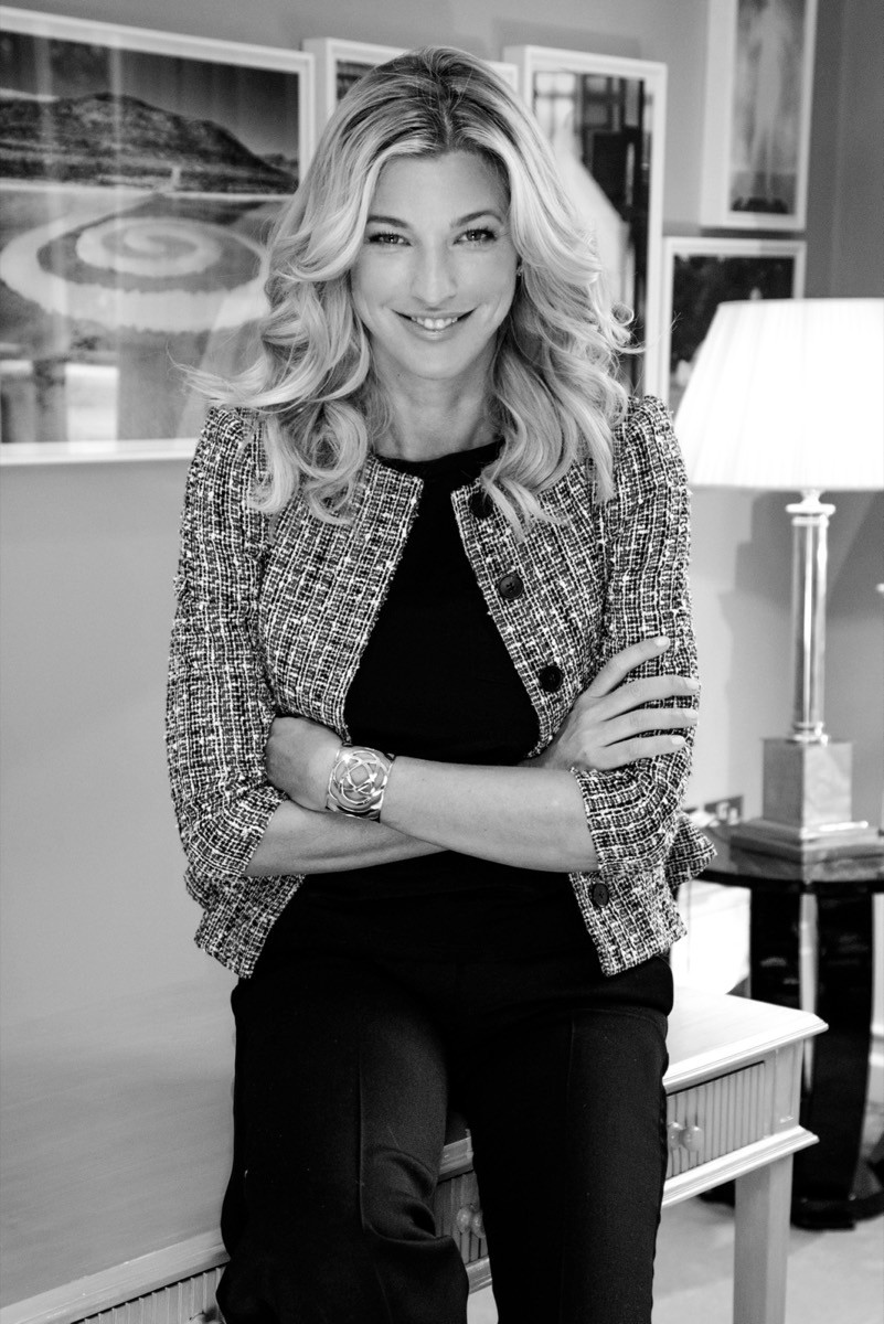 Black-and-white portrait of Nicole Brachetti Peretti in a tweed jacket, seated with her arms crossed